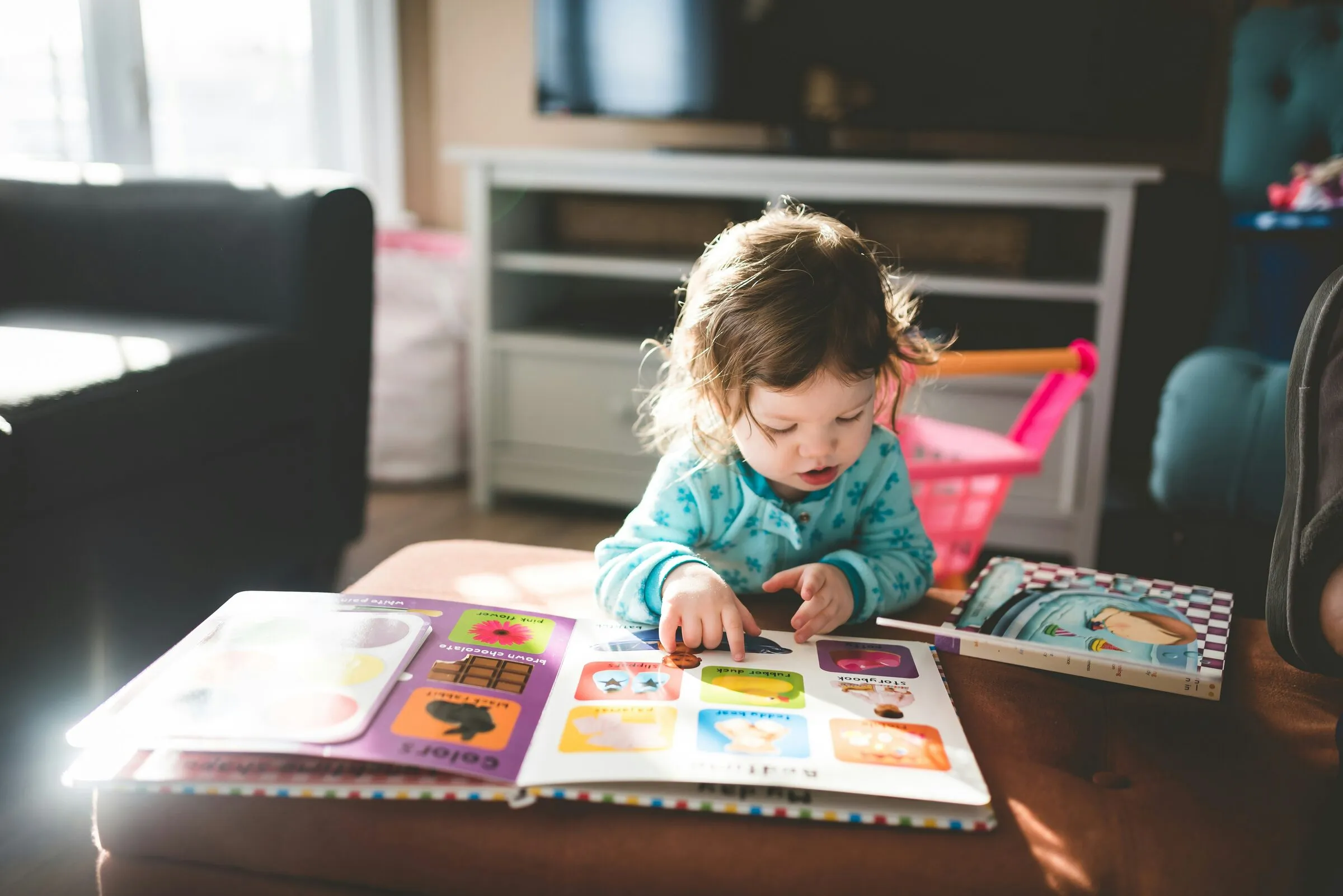 A toddler exploring a colourful picture book